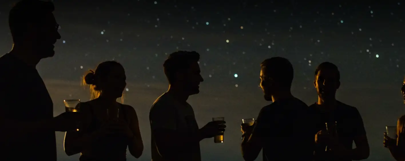 People gathering under starry night sky